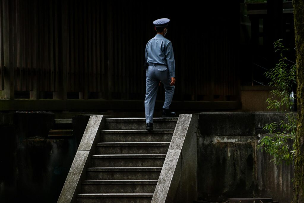 Ecommerce Basic Service: A uniformed security officer walks up the stairs, demonstrating profe